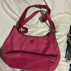 Fushia pink perforated shoulder bag. detach strap.1zip&2 slide pocket.says coach